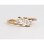 An 18ct yellow gold 3 stone diamond crossover ring 1.9 grams, size L 1/2