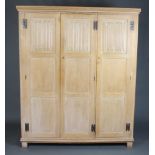 A Heals White Spot limed oak triple wardrobe with moulded cornice enclosed by 3 panelled doors