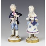 A pair of German porcelain figures of a young girl and boy, raised on circular bases 16cm