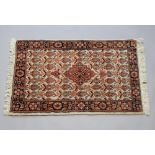 A brown and tan ground Persian Brojerd rug with central medallion within multi row borders 96cm x