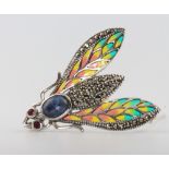 A silver enamel, marcasite and ruby cabochon sapphire bug brooch