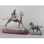 A metal figure of a walking horse raised on a rectangular base 17cm h x 15cm w x 5cm d together with