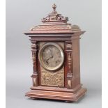 A 19th Century Continental striking bracket clock with silvered dial and Roman numerals contained in