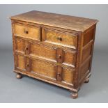 A 17th Century style oak chest of 2 short and 3 long drawers with tore handles and geometric