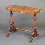 A Victorian figured walnut centre table of serpentine outline, raised on turned supports with carved