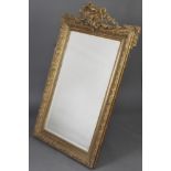 A 19th Century rectangular bevelled plate wall mirror contained in a decorative gilt frame 140cm x