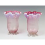 A pair of Victorian vaseline glass vases with wavy rims 16cm