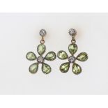 A pair of silver gilt Edwardian style peridot and diamond floral cluster earrings