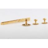 A 9ct yellow gold tie pin, 4.5 grams and a set of three 18ct yellow gold studs, 3 grams