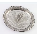 An Indian oval repousse silver dish decorated with a girl blowing a horn 20cm, 138 grams