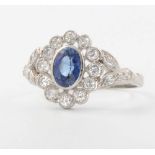 A platinum oval sapphire and diamond cluster ring, the sapphire approx 1.2ct surrounded by brilliant