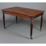 A Victorian rectangular mahogany library table, raised on turned and reeded supports ending in brass