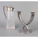 An Edwardian silver plated mounted glass ewer and a 2 light candelabrum