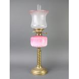 A Victorian opaque pink glass oil lamp reservoir raised on a gilt spiral turned column with later