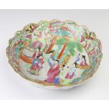 A late 19th Century famille rose shaped dish decorated figures on a pavillion terrace, 27cm This