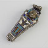 A silver and enamelled pendant in the form of a sarcophagus with mummy 3.5cm