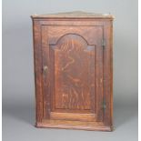 A 19th Century oak hanging corner cabinet, interior fitted shelves with moulded cornice and enclosed