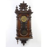 A 19th Century Vienna style regulator with paper dial, Arabic numerals and grid iron pendulum,