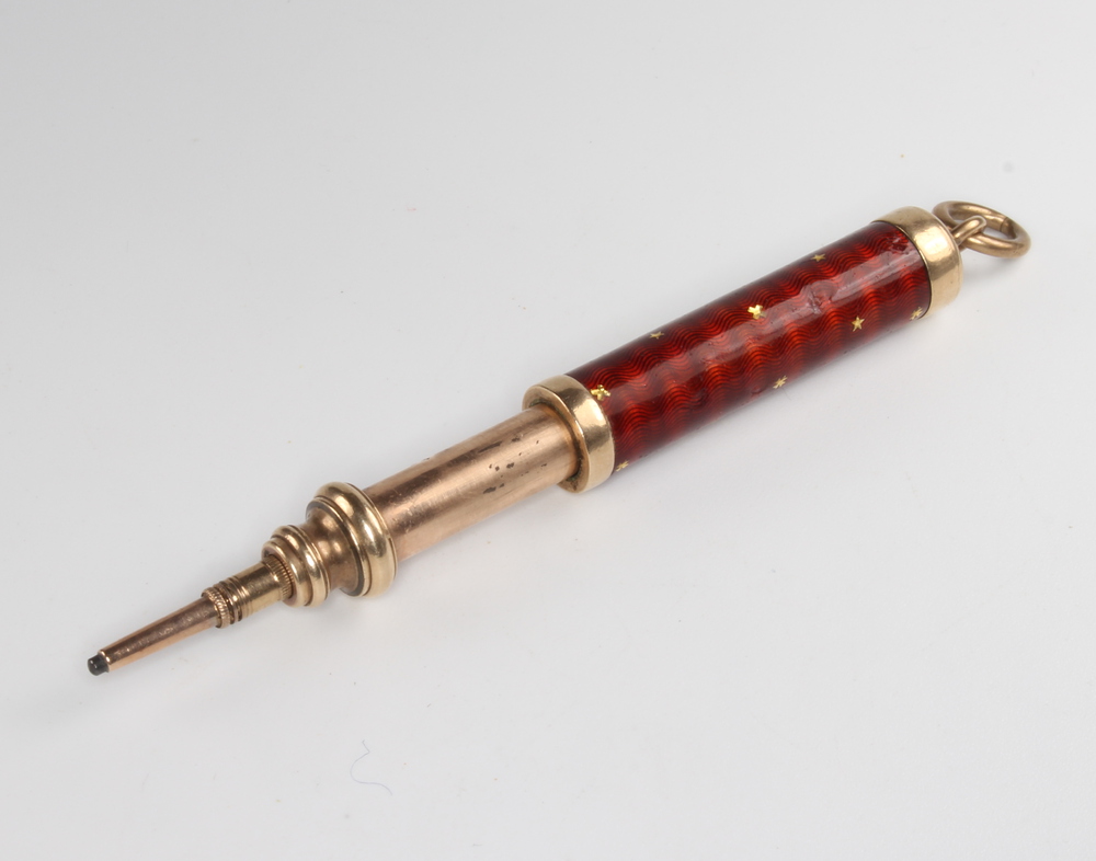 An Edwardian gilt and enamelled propelling pencil by S Morden & Co, 10cm There is a chip to the