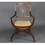 An Edwardian inlaid mahogany stick and rail back open arm carver chair with X framed support and