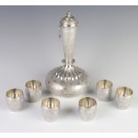 A Persian silver spirit decanter and lid with 6 tots decorated with scrolling flowers 605 grams