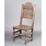 A Victorian 17th Century style carved oak hall chair with arched back and solid seat, raised on