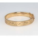A 9ct yellow gold hollow bangle with engraved decoration 15.3 grams