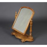 A Victorian arched plate dressing table mirror contained in a bleached mahogany swing frame,