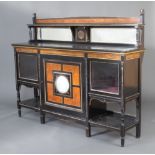 A Victorian ebonised and amboyna sideboard with raised mirrored back fitted a cupboard enclosed by a