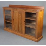 An Anglo Indian display cabinet with raised back and arcaded decoration, fitted shelves enclosed