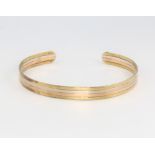 A 9ct three colour torque bangle, 8.6 grams