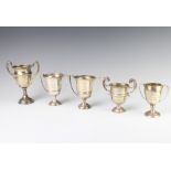 A silver sports trophy, London 1905 and 4 others, 323 grams