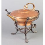 An Art Nouveau dresser style copper tea kettle, raised on a wrought iron stand, the kettle handle