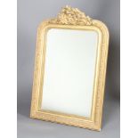 A 19th Century arch shaped plate mirror contained in a decorative gilt frame with swag crest 117cm h