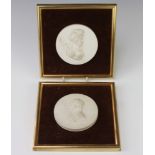 A pair of Victorian bisque circular portrait plaques of a lady and gentleman 10cm