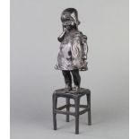 An Art Nouveau style Continental bronze figure of a standing bonneted girl on stool 30cm x 8cm x 7cm