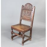 A Victorian 17th Century style carved oak hall chair with solid seat, raised on turned and block