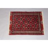 A red and blue ground Belouche rug with stylised octagons to the centre within a multirow border