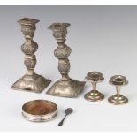 A pair of repousse silver candlesticks (marks rubbed) and minor items
