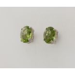 A pair of silver peridot ear studs