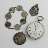 A silver cased keywind pocket watch, 2 fobs and a bracelet The watch dial is cracked and is not