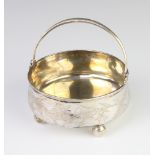 A Russian silver 84 standard swing handled basket decorated with flowers, raised on ball feet 133