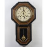 An American 10 day wall clock with paper dial and Roman numerals contained in a pine case with