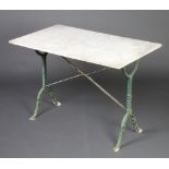 A Victorian white marble and wrought iron rectangular garden table raised on outswept supports