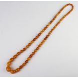 A string of amberoid beads, 66cm