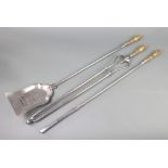 A Regency polished steel and brass 3 piece fireside companion set comprising poker, shovel and tongs