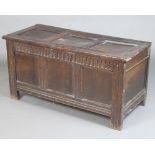 A 17th/18th Century oak coffer of panelled construction with arcaded decoration and hinged lid