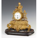 A Victorian French timepiece with enamelled dial contained in a gilt painted spelter case surmounted