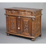 A 19th Century carved oak cabinet fitted 2 long drawers above panelled doors, the drawers mask