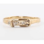 A 9ct yellow gold diamond set buckle ring, size P, 1.3 grams